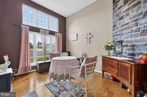 a dining room with furniture and wooden floor