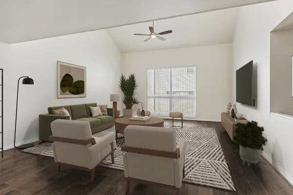 a living room with furniture a flat screen tv and a window