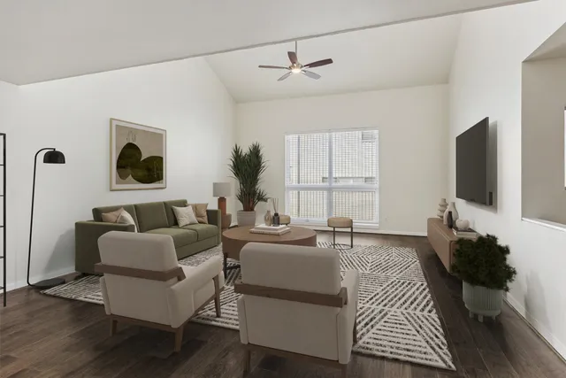 a living room with furniture a flat screen tv and a window