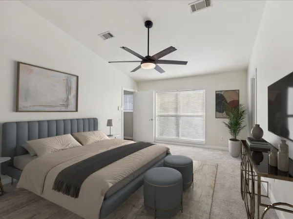 a bedroom with a bed a window and a flat screen tv