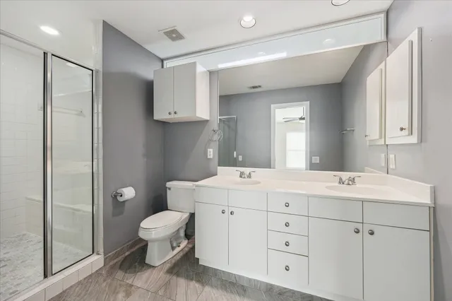 a spacious bathroom with a toilet sink and mirror