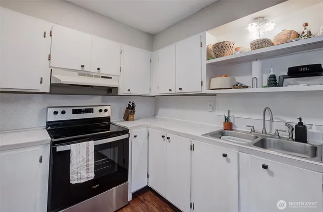 a kitchen with cabinets appliances and a sink