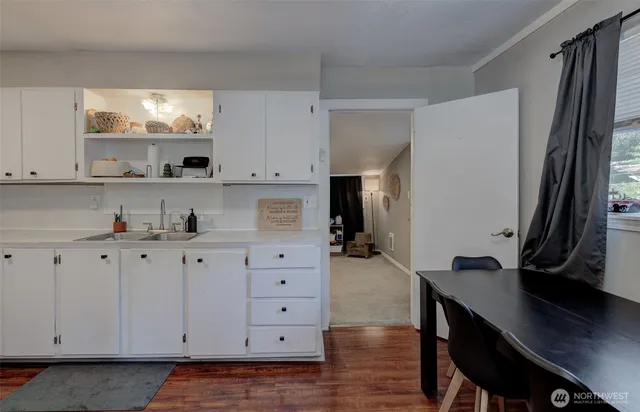 a kitchen with cabinets appliances and a window
