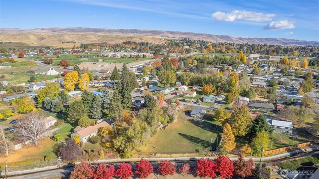 an aerial view of residential houses with city view