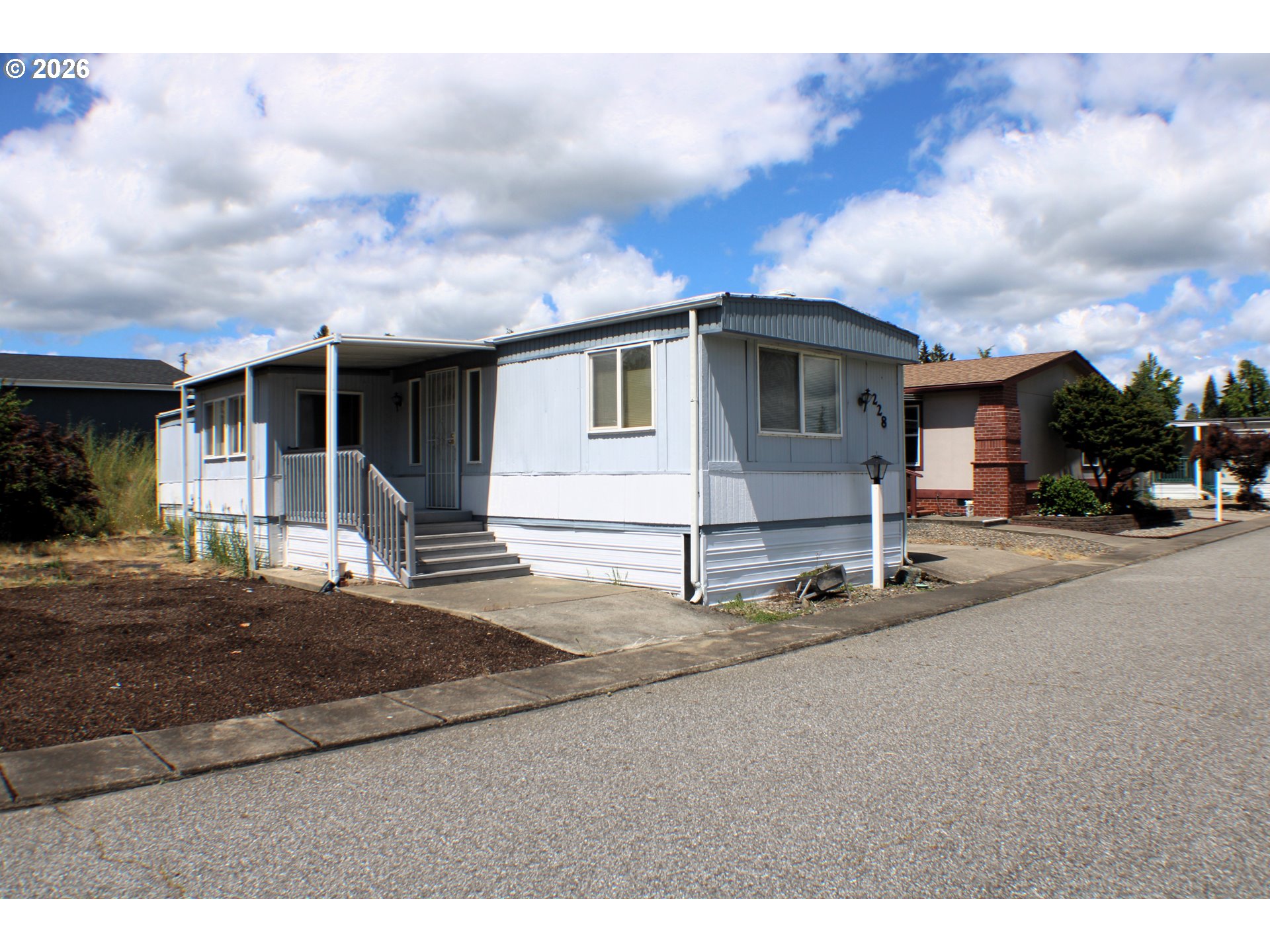 228 Estate Loop Winston, OR 97496 - Photo 1 of 19 a front view of a house with a yard and garage