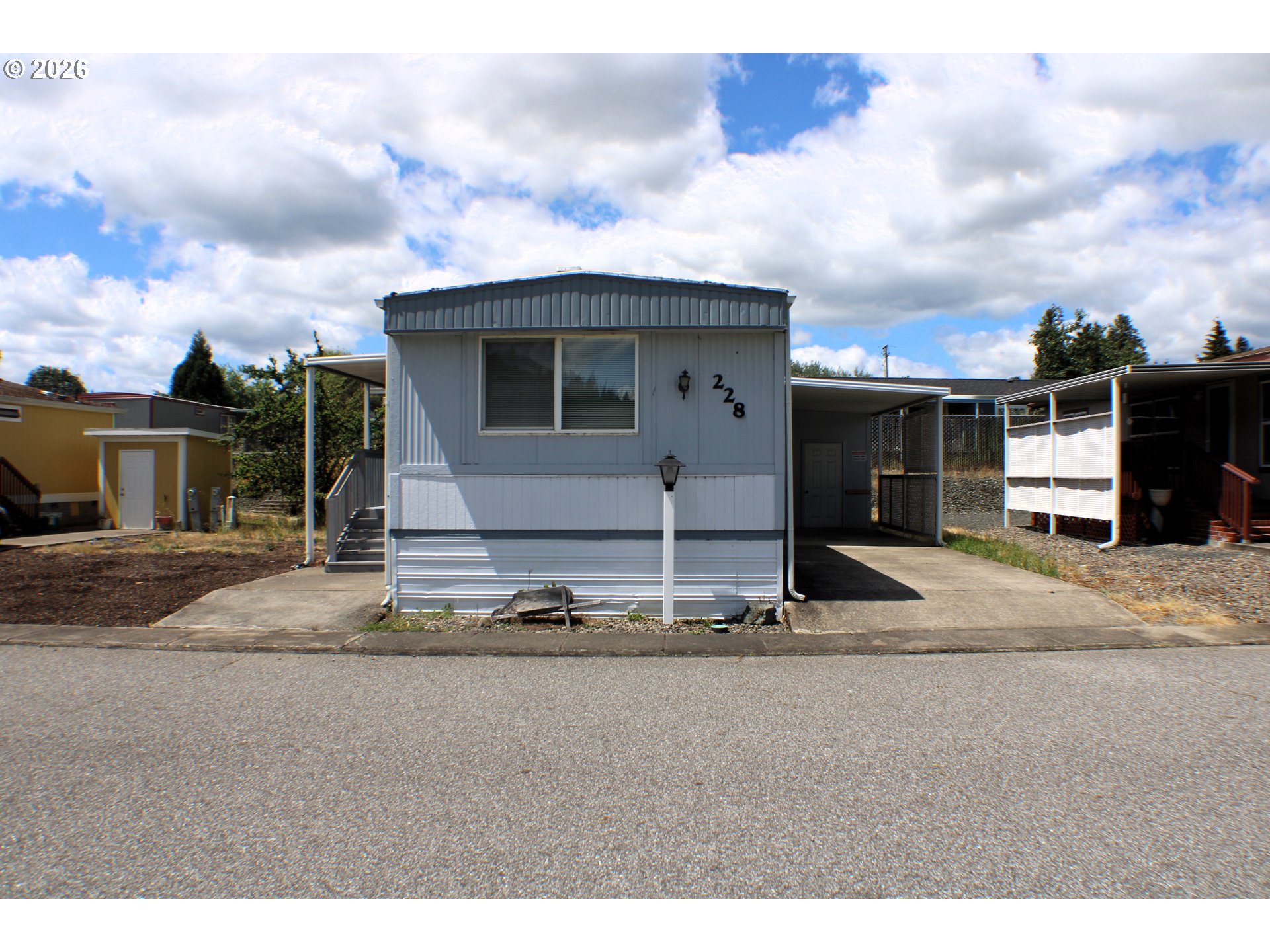 228 Estate Loop Winston, OR 97496 - Photo 2 of 19 a front view of a house with a yard