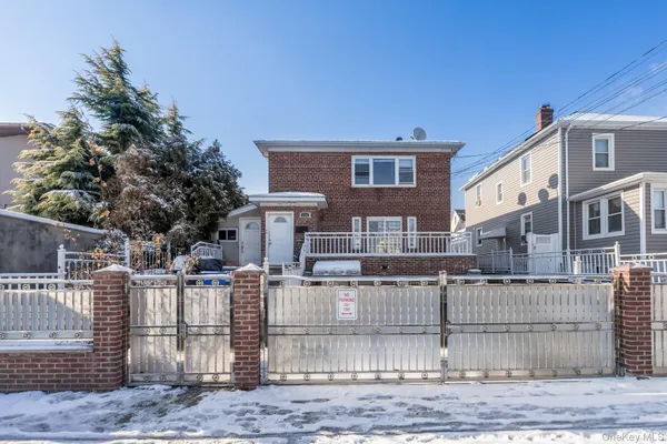 a front view of a house with a fence