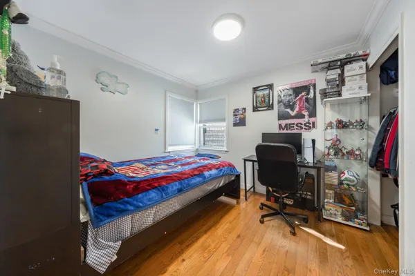 a bedroom with bed and a desk