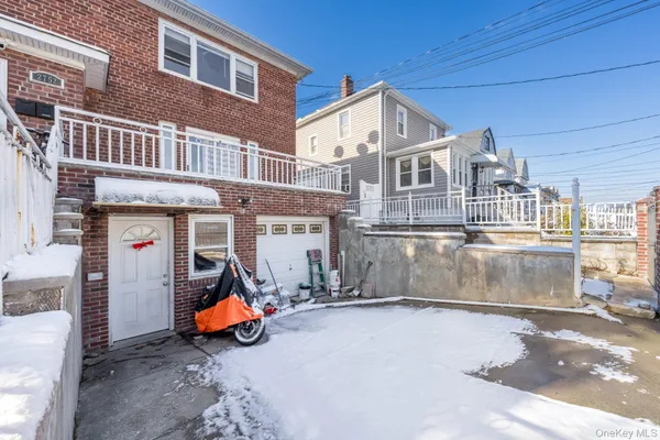 a view of a house with a patio and wooden fence