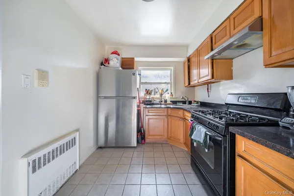 a kitchen with a refrigerator and a stove