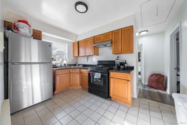 a kitchen with stainless steel appliances granite countertop a refrigerator and a sink