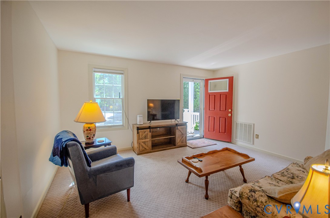 12500 Musical Lane Midlothian, VA 23113 - Photo 41 of 51 Living area featuring a vibrant red entry door wit