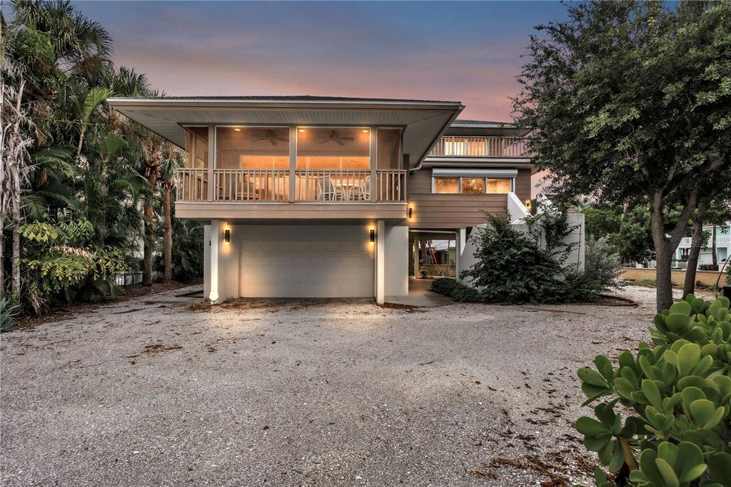103 Sunset Lane Anna Maria, FL 34217 - Photo 1 of 54 a front view of a house with a yard and garage