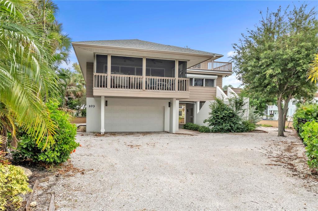 103 Sunset Lane Anna Maria, FL 34217 - Photo 2 of 54 a front view of a house with a garden