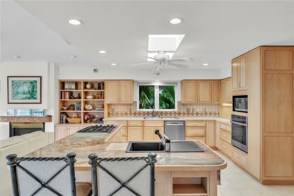 103 Sunset Lane Anna Maria, FL 34217 - Photo 21 of 54 a kitchen with stainless steel appliances granite countertop a stove refrigerator and a view of living room