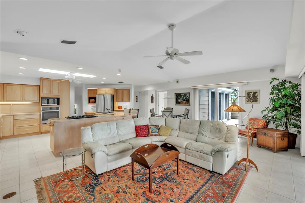 103 Sunset Lane Anna Maria, FL 34217 - Photo 24 of 54 a living room with furniture and a chandelier