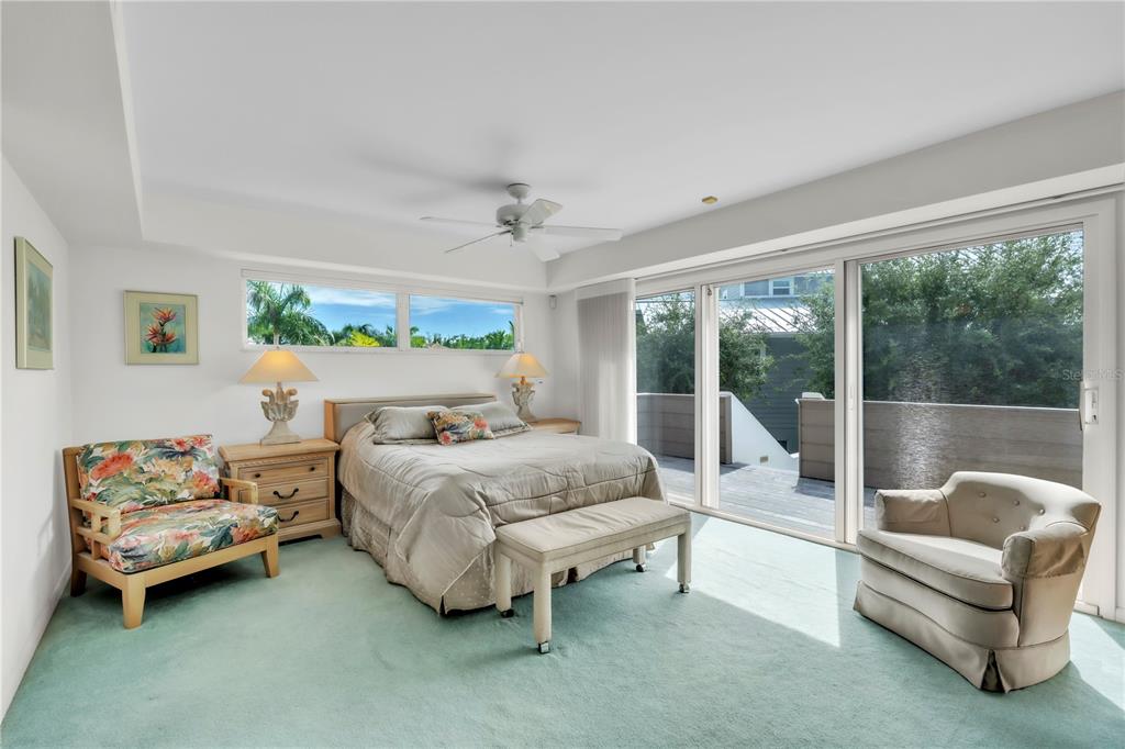 103 Sunset Lane Anna Maria, FL 34217 - Photo 29 of 54 a bedroom with a bed and a couch next to a window