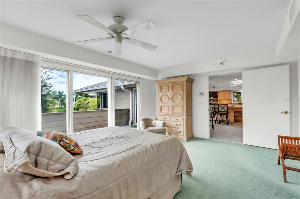 103 Sunset Lane Anna Maria, FL 34217 - Photo 30 of 54 a bedroom with a bed and a large window