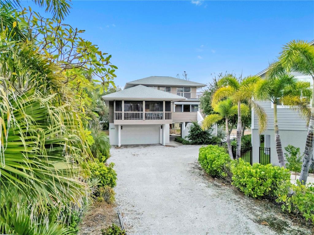 103 Sunset Lane Anna Maria, FL 34217 - Photo 3 of 54 a front view of a house with a garden
