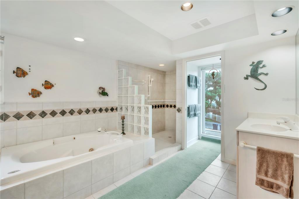 103 Sunset Lane Anna Maria, FL 34217 - Photo 32 of 53 a bathroom with a bathtub and a shower