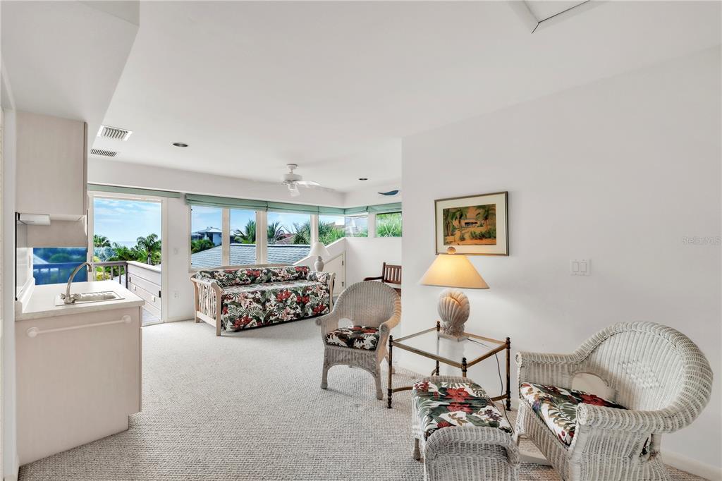 103 Sunset Lane Anna Maria, FL 34217 - Photo 38 of 53 a bedroom with furniture and a chandelier