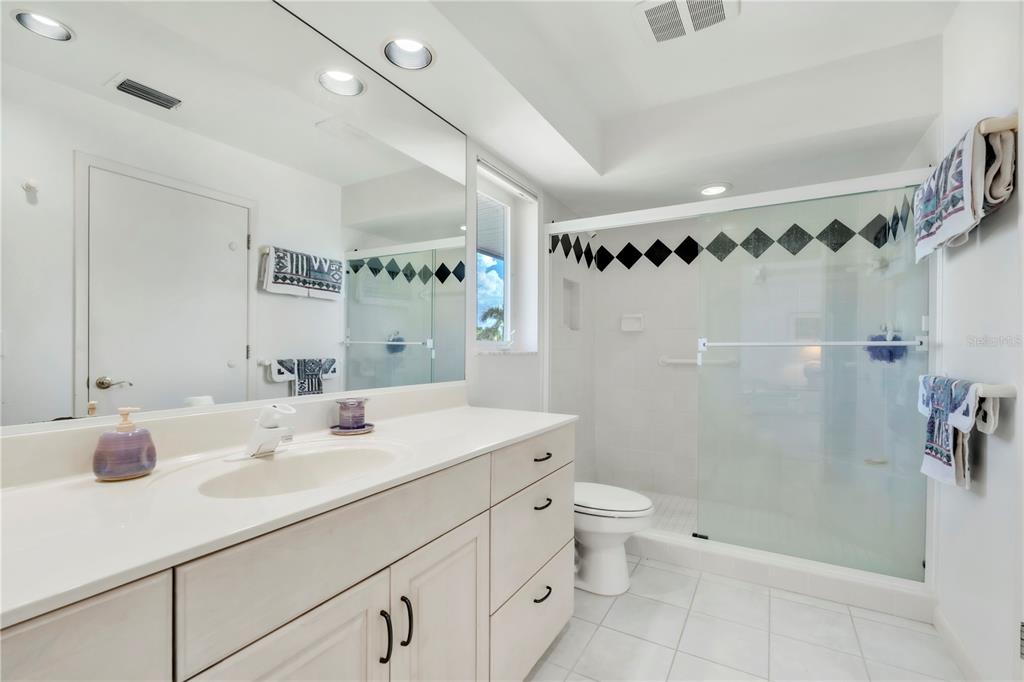 103 Sunset Lane Anna Maria, FL 34217 - Photo 41 of 54 a bathroom with a sink a toilet and shower