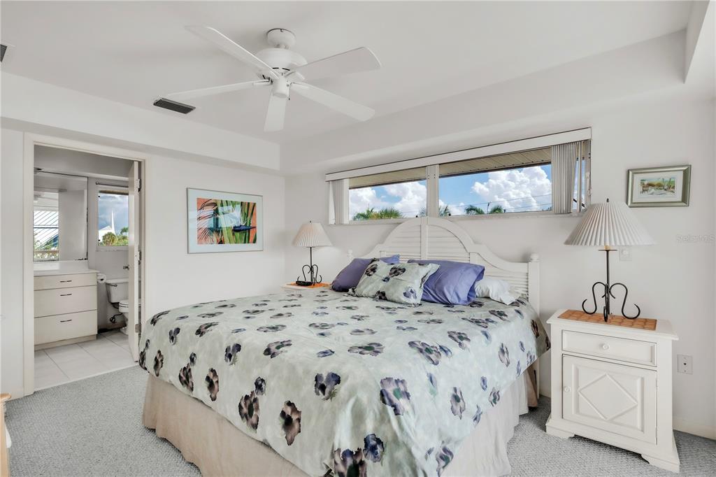 103 Sunset Lane Anna Maria, FL 34217 - Photo 44 of 54 a bedroom with a large bed and a window