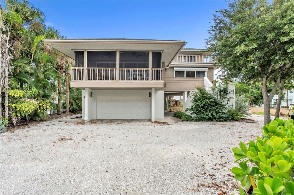 103 Sunset Lane Anna Maria, FL 34217 - Photo 5 of 54 a front view of a house with a garden