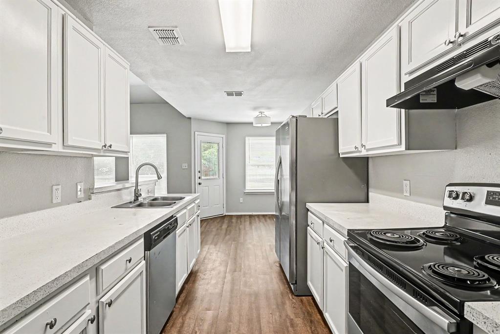 138 Kings Way Drive Rhome, TX 76078 - Photo 5 of 16 a kitchen with stainless steel appliances granite countertop a stove and a refrigerator