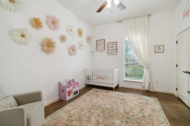 a spacious bedroom with a bed and a chandelier