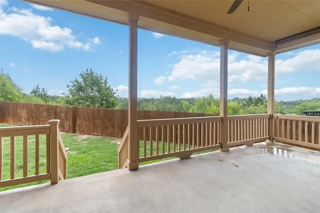 a aerial view of a house with a yard and trees all around