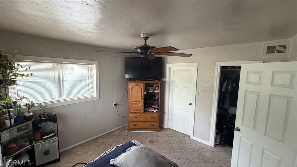 475 Wiltsey Road Red Bluff, CA 96080 - Photo 15 of 33 a bedroom with a bed and a chandelier