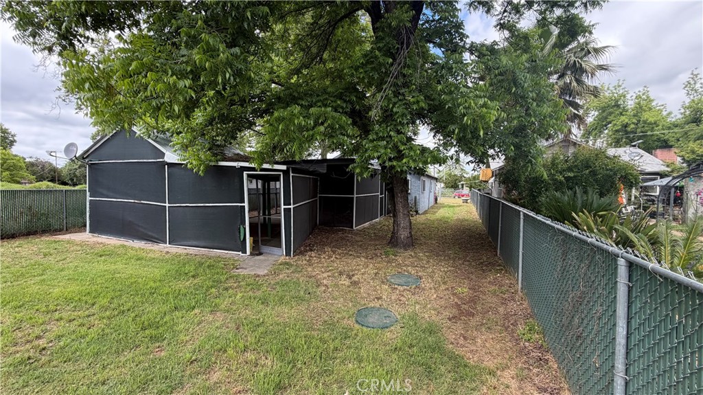 475 Wiltsey Road Red Bluff, CA 96080 - Photo 25 of 33 a view of a backyard with floor to ceiling window and wooden fence