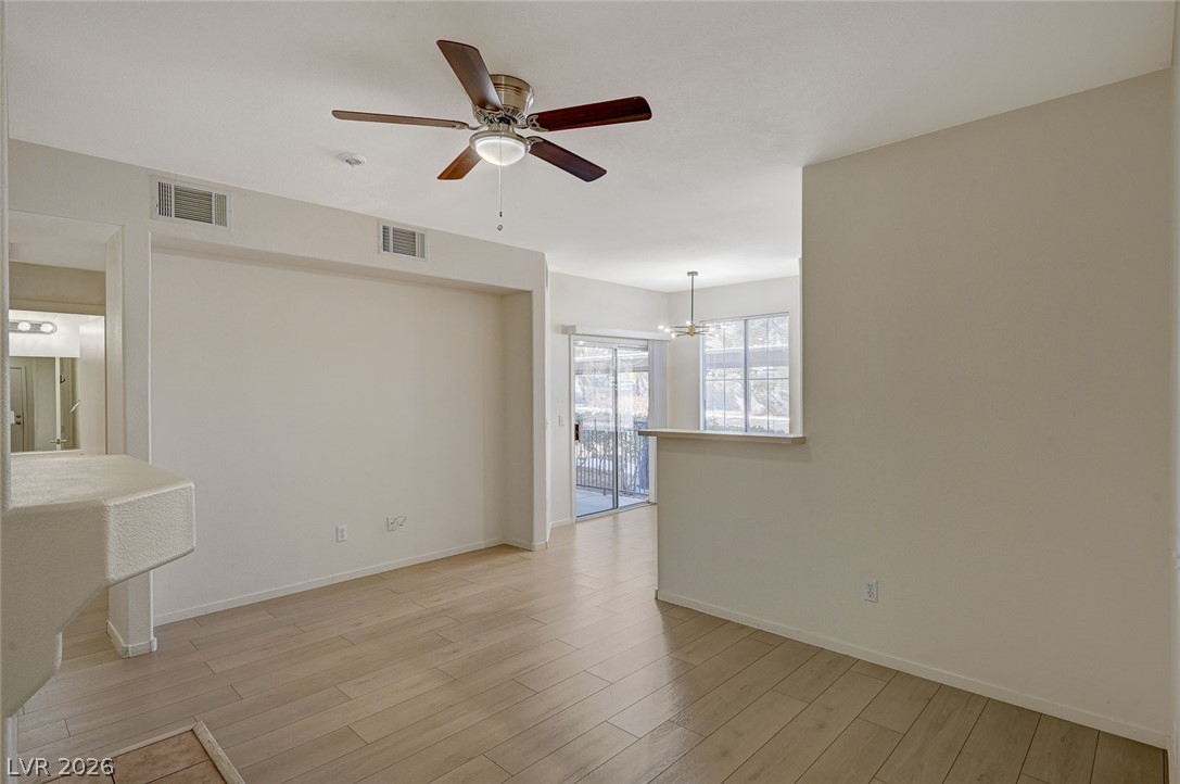 9050 West Warm Springs Road, Unit 1147 Las Vegas, NV 89148 - Photo 2 of 36 The generously sized living space is anchored by light wood flooring and includes direct patio access.