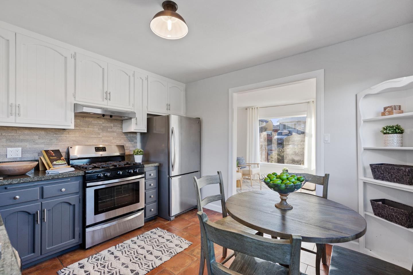 3946 La Colina Road El Sobrante, CA 94803 - Photo 12 of 49 a kitchen with stainless steel appliances granite countertop a stove a refrigerator a sink a dining table and chairs with wooden floor