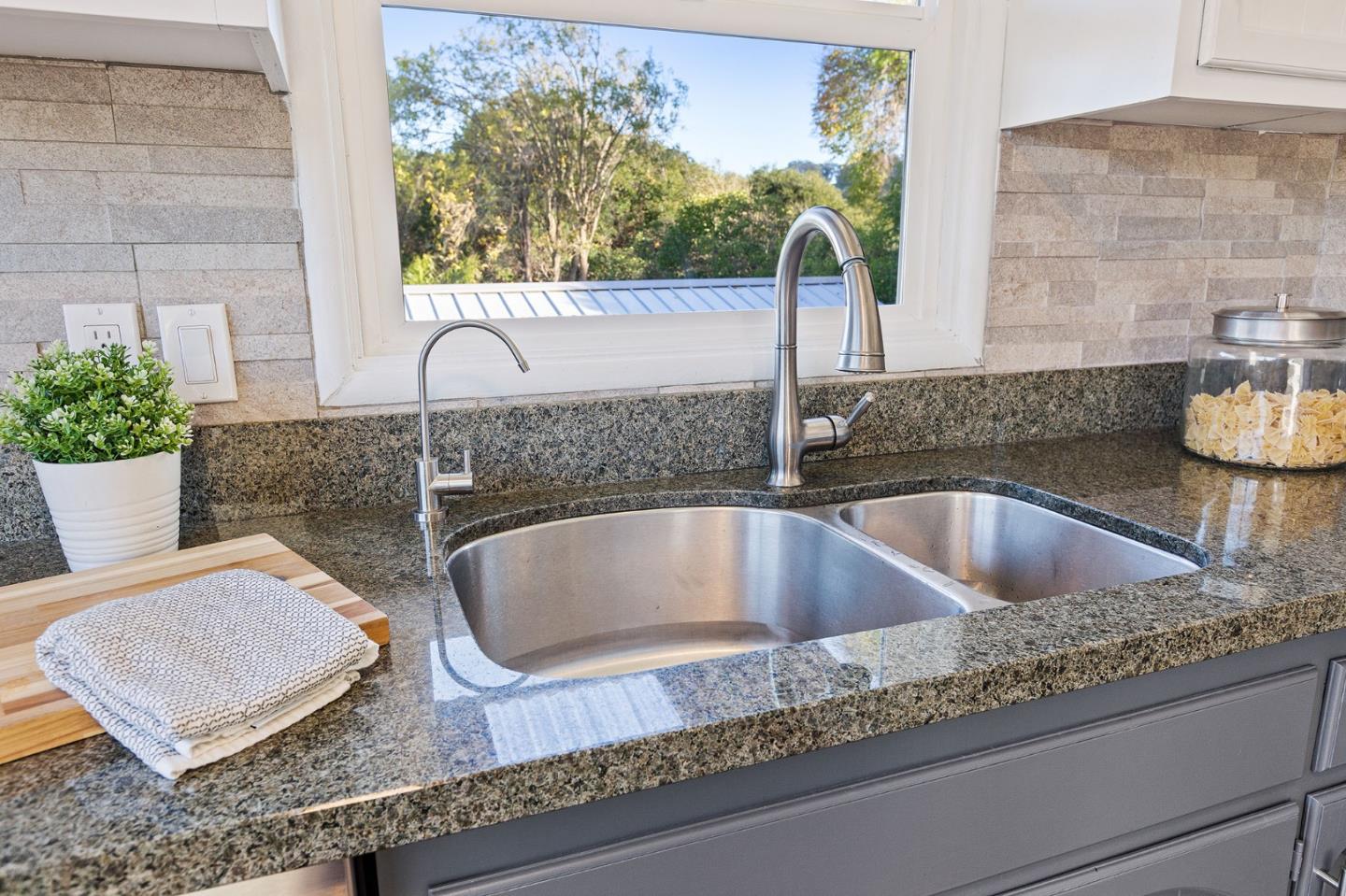 3946 La Colina Road El Sobrante, CA 94803 - Photo 14 of 49 a bathroom with a granite countertop sink and a potted plant