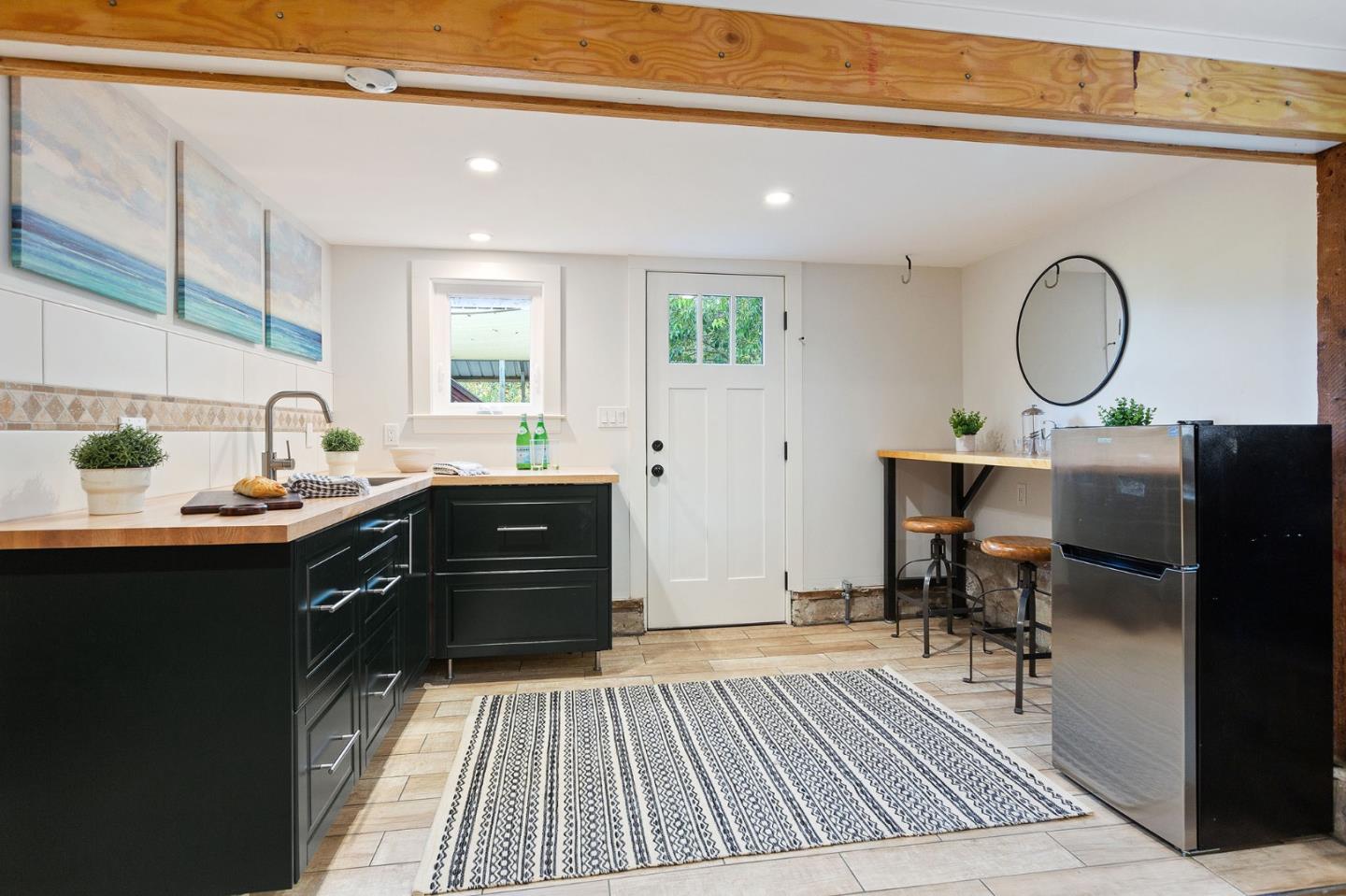 3946 La Colina Road El Sobrante, CA 94803 - Photo 29 of 49 a kitchen with granite countertop a stove a sink and a dining table with wooden floor