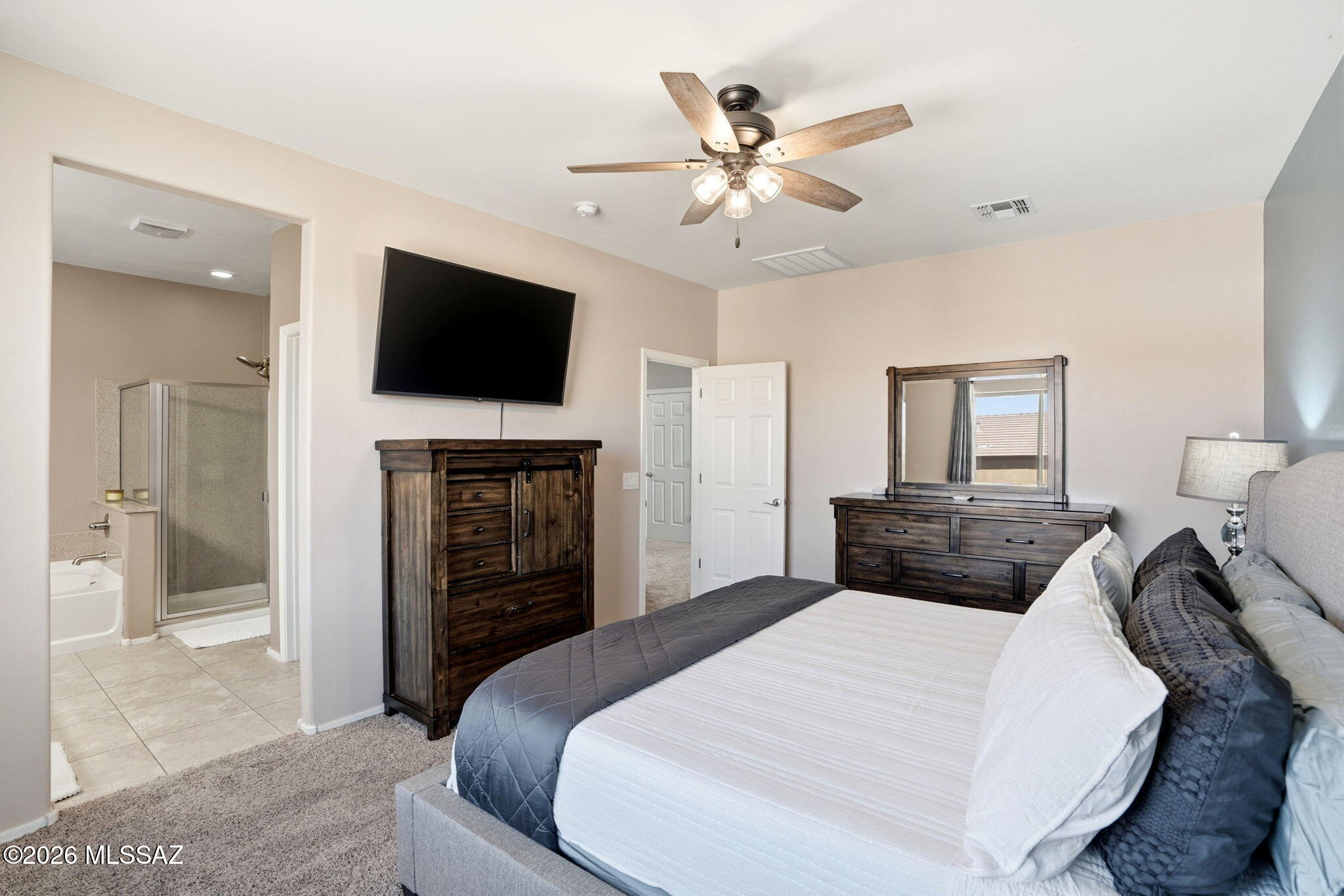 211 East Refuge Loop Vail, AZ 85641 - Photo 17 of 48 a bedroom with a large bed and a flat screen tv