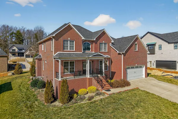 a front view of a house with a yard outdoor seating and garage