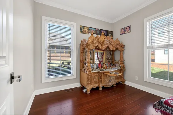 a bedroom with a bed window and a flat screen tv