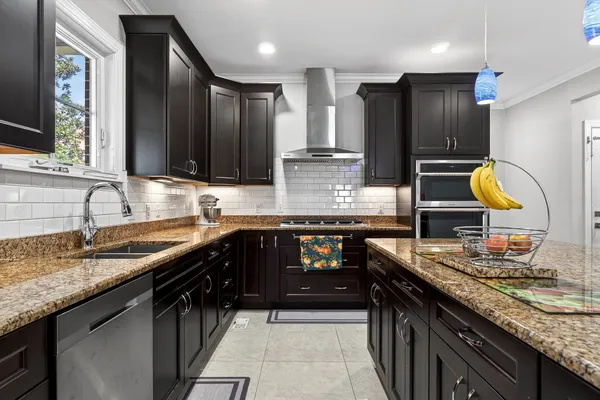 a kitchen with stainless steel appliances granite countertop a stove and a microwave