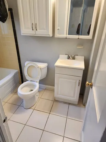 a bathroom with a bathtub and a window