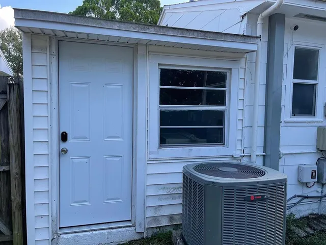 a view of a house with backyard tub and entertaining space