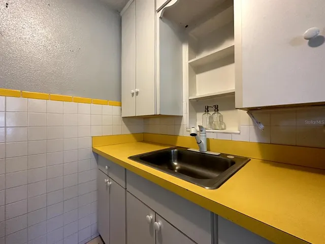 a kitchen with a sink and cabinets