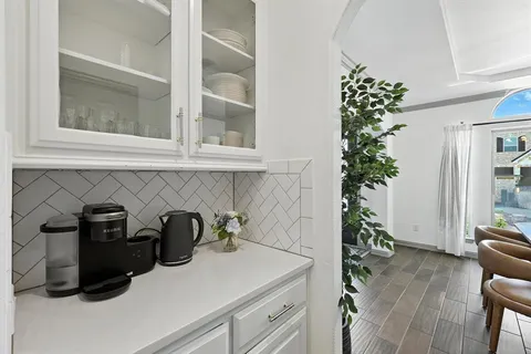 a kitchen with a refrigerator and a more cabinets