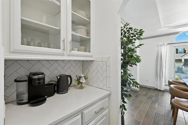 a kitchen with a refrigerator and a more cabinets