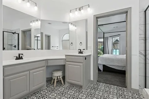 a en suite bathroom with a sink a toilet and a mirror