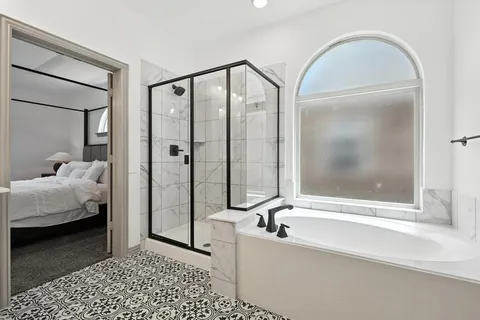 a bathroom with a tub and shower