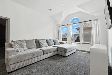 a living room with furniture and a large window
