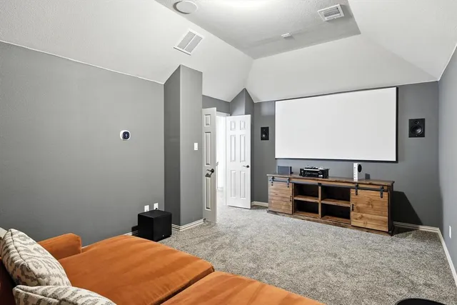a bedroom with a bed and flat screen tv